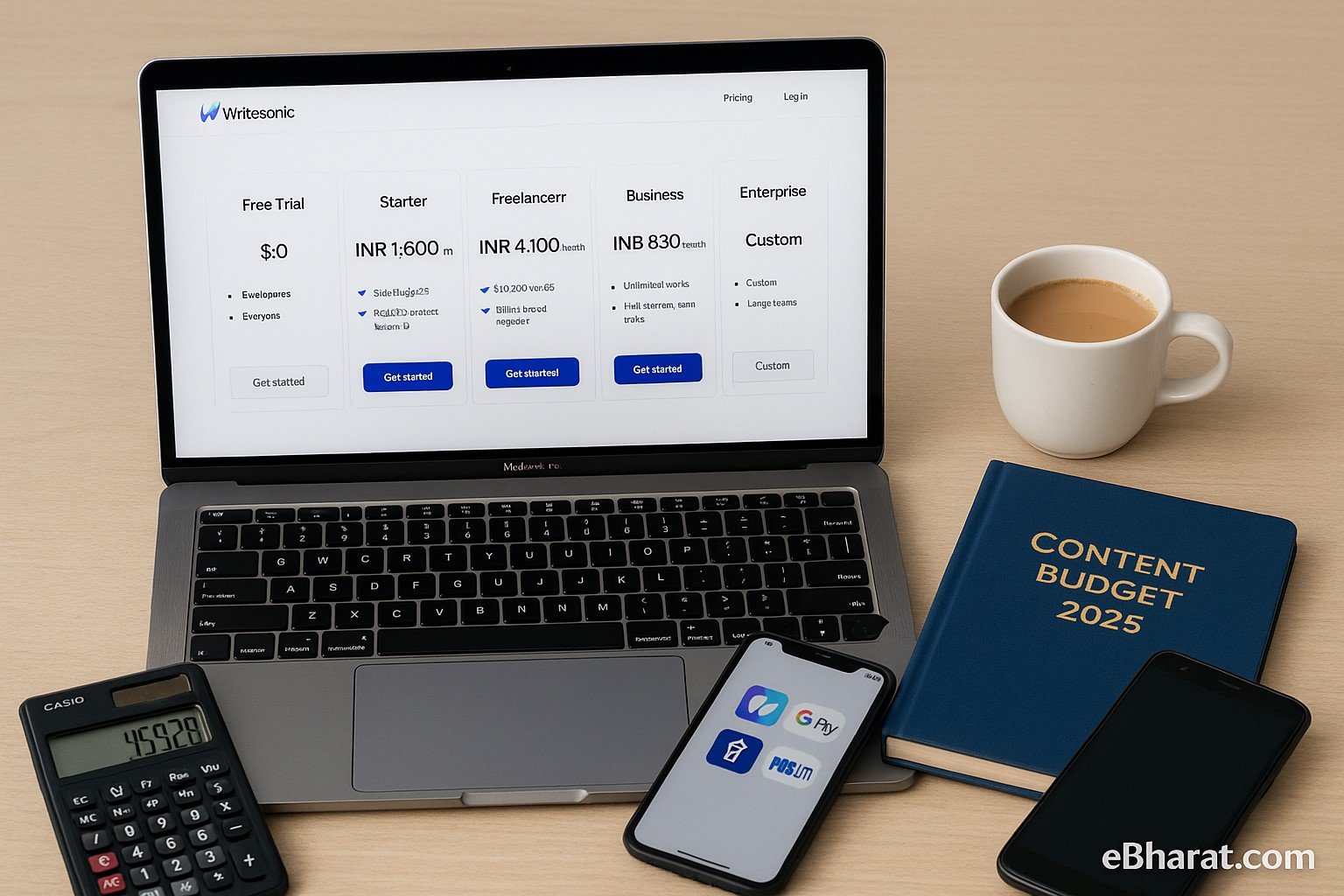 "Laptop displaying Writesonic pricing plans with Free, Starter, Freelancer, Business, and Enterprise options, alongside Content Budget 2025 diary, smartphone with UPI apps, calculator showing rupee amount, and cup of chai."